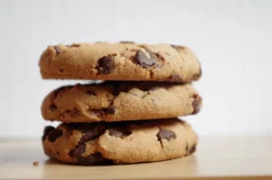 Freshly baked protein cookies with chocolate chips and oats on a wooden table